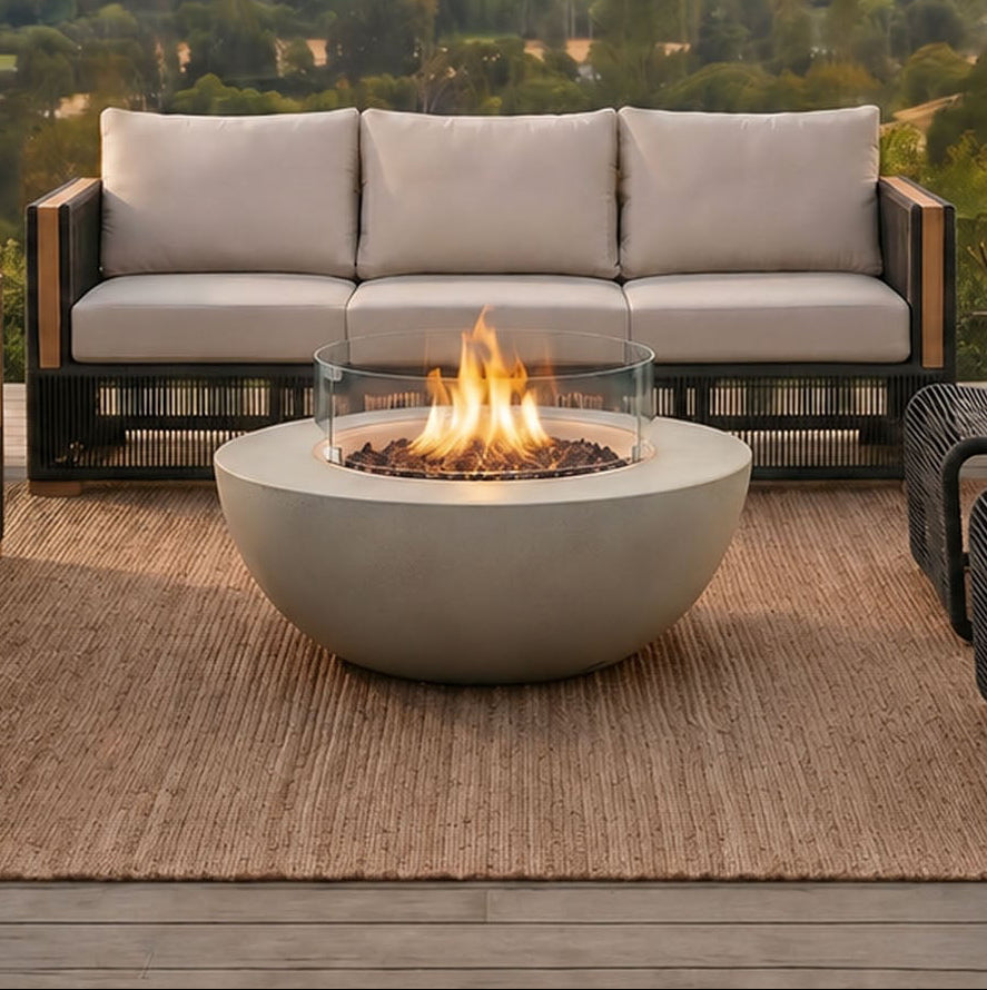 Outdoor patio setup with fire pit and seating area overlooking a scenic landscape.