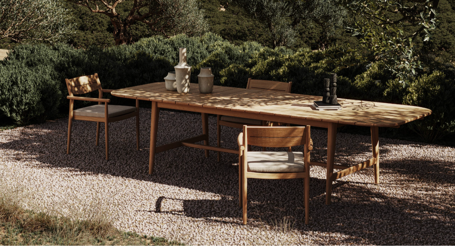 Wooden outdoor dining table with chairs in a natural setting