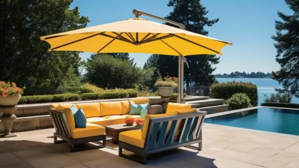 yellow umbrella over a sofa set by a pool on a sunny day