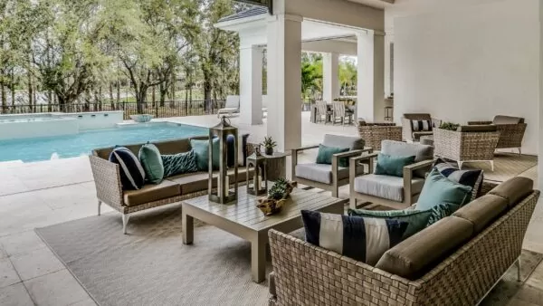 large home with patio furniture under a covered patio