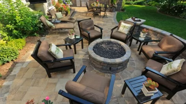 lots of outdoor patio chairs around a fire pit
