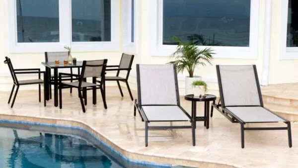 sling patio furniture next to a pool